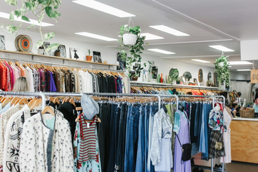 Rekken met tweedehands kleding in een kringloopwinkel